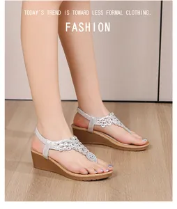 Close-up of Bohemian wedge sandals featuring sparkling rhinestone flower patterns