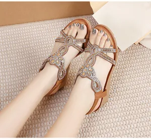 Detail of bohemian wedge sandals with rhinestone straps and comfortable thick soles
