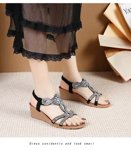 Detail of bohemian wedge sandals featuring shimmering silver rhinestones on black T-straps