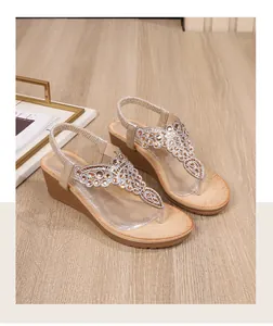 Detail view of the rhinestone decorations and wedge sole on these stylish flip-flop sandals