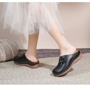 Detail of black wedge mules with hollow flower pattern and thick soft soles for women