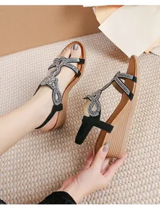 Detail of bohemian wedge sandals with sparkling rhinestones and vertical textured sole