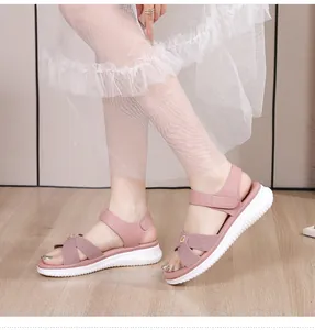 Side view of mauve bohemian wedge sandals with crisscross straps and gold buckles