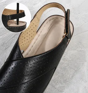 Detail of black summer sandals featuring breathable PU material and adjustable velcro strap