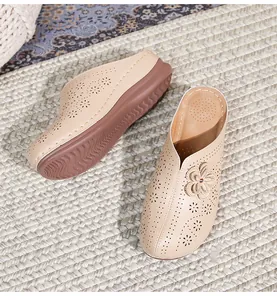 Detailed top view of beige platform clogs featuring floral cutouts and 3D petals
