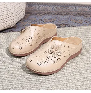 Detail of beige hollow-out platform mules featuring 3D flower decor and breathable footbed