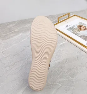 Macro detail of wave-textured anti-slip PU outsole on beige summer beach sandals