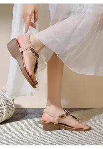 Detail of bohemian wedge sandals with ethnic embroidery and beads on the ankle strap