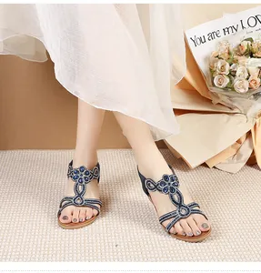 Detail of navy blue Bohemian sandals with blue gems and sequins on a wedge heel