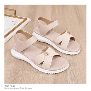 Detail of beige Bohemian sandals featuring cross straps, pearl buckles and thick soles