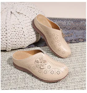 Detailed view of beige wedge mule with hollow flower patterns and breathable footbed