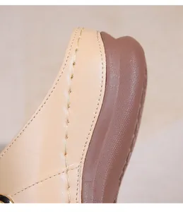 Détail de la texture en cuir beige et de la semelle en caoutchouc marron avec coutures