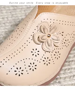 Detail of apricot hollow-out leather shoes with 3D floral accent and soft matte texture