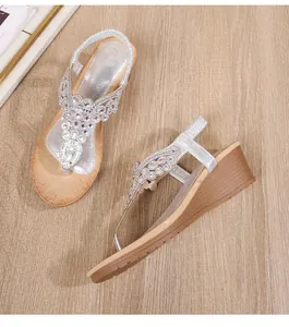 Detail of silver bohemian wedge sandals featuring intricate rhinestone and bead embellishments