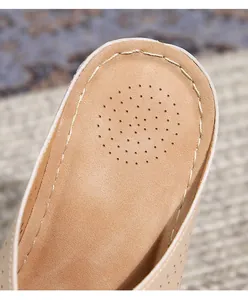 Detail view of the beige hollow sole sandals showing fine stitching and breathable heel holes