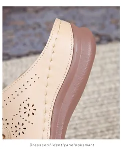 Detailed macro view of beige hollow-out leather upper with yellow hand-stitched seams