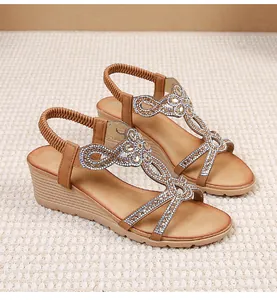 Close-up of Bohemian wedge sandals featuring intricate rhinestone floral patterns and elastic strap