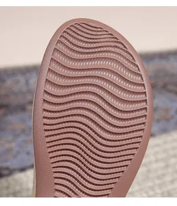 Detail shot of pink rubber sole with anti-slip horizontal wave texture for stability