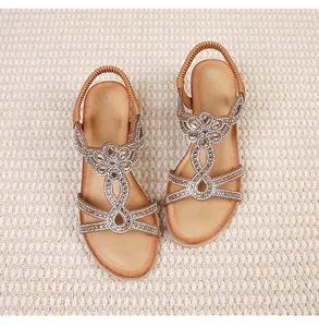 Detail of bohemian sandals with sparkling rhinestones and elastic woven heel strap