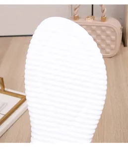 Detailed view of white sandal sole featuring non-slip horizontal grip and size 37 mark