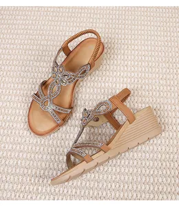 Detailed view of bohemian wedge sandals featuring sparkling rhinestone-studded cross straps