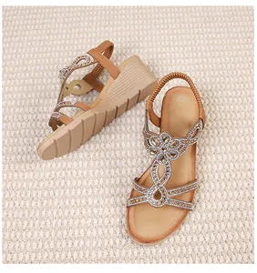 Detailed view of bohemian wedge sandals featuring hollow straps and sparkling rhinestones