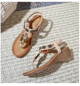 Detail of bohemian wedge sandals featuring ethnic flower beads and comfortable T-strap