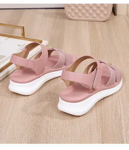Detail showing the pink strap sandals with thick white anti-slip sole and metal buckle