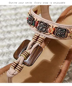 Detail of bohemian wedge sandal featuring rhinestone flower buckle and braided straps