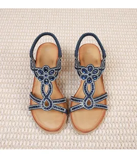 Close-up of bohemian navy blue sandals featuring intricate rhinestone and beadwork detail