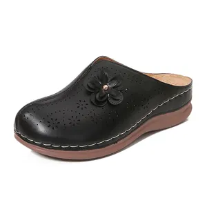 Women's black hollow-out platform mules with floral patterns and contrast stitching