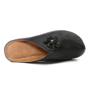 Women's black hollowed-out closed toe clogs with floral pattern and soft thick sole
