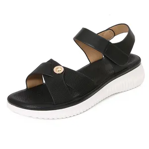 Bohemian black sandals with crossed straps, gold metal buckle, and thick white wavy soles