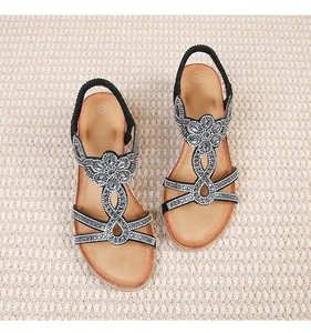 Detailed top view of black T-strap sandals with silver rhinestones and size 37 mark