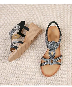 Detail of bohemian wedge sandals featuring rhinestone patterns and textured EVA soles
