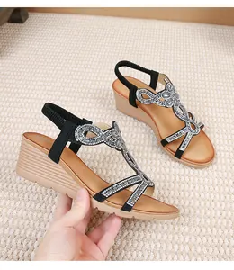 Detail of bohemian wedge sandals featuring sparkling rhinestone patterns and thick platform soles