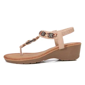 Beige Bohemian wedge sandals with metallic floral rhinestones and elastic heel strap