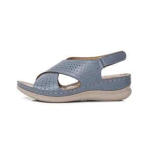 Women's blue wedge sandals with cross-strap laser-cut design and stitch detail