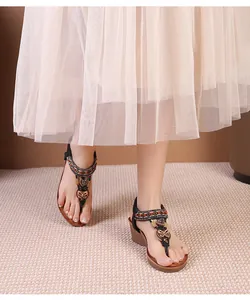 Close-up of bohemian wedge sandals featuring ethnic embroidery and bead decorations