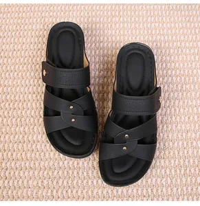 Top view of black casual platform sandals with crossover straps and gold metal buckles