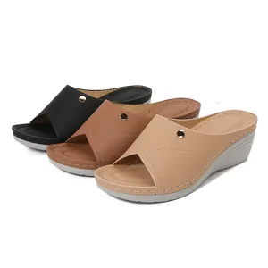 Women wedge sandals in black, tan and beige with cross straps and golden buckles