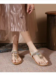 Detail of bohemian flat sandals featuring golden cut-outs, sequins, and colorful beadwork