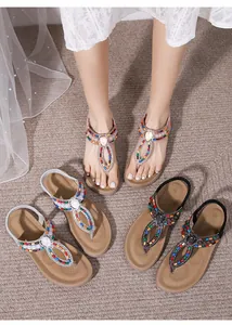 Detail of bohemian thong sandals with colorful beads and rhinestone water drop pattern