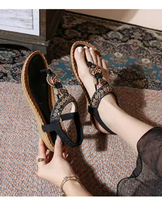 Detail of bohemian flat sandals featuring colorful beads and ethnic disc ornaments