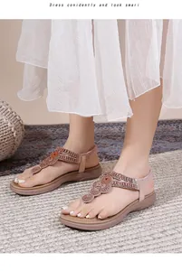 Detail of bohemian flat sandals featuring sparkling rhinestones and beaded petal pattern