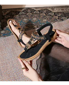 Close-up of Bohemian flat sandals with butterfly beadwork and sequined straps