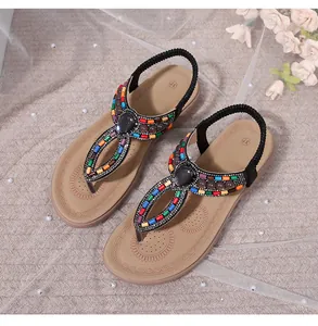 Top view of bohemian flat sandals with colorful beads and grey gemstone detail