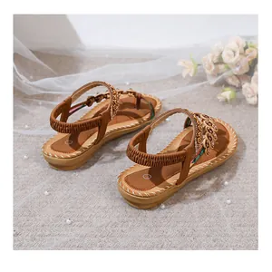 Detail of bohemian flat sandals featuring intricate crystal beading and elastic straps