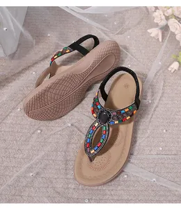 Detail of bohemian flat sandals featuring colorful beads and mandala printed footbed