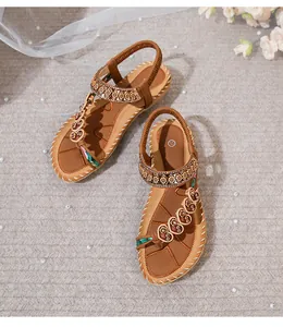 Detail of bohemian flat sandals with ethnic patterns, rhinestones and size 37 mark